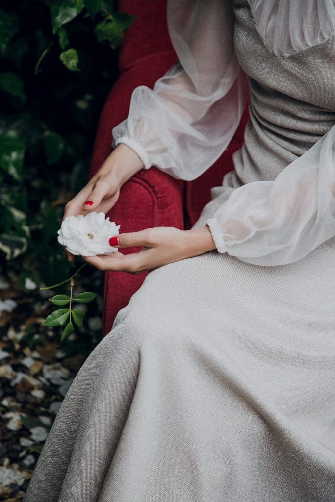 Woman in White Dress Holding White Rose